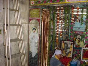 Image of Chaman Lal on Mandir Wall with images of Sikh Gurus