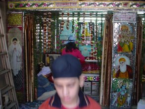 Image of Chaman Lal on Mandir Wall with images of Sikh Gurus