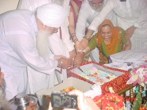 Birthday Party for Chaman Lal, cutting cake in front of Guru Sahib
