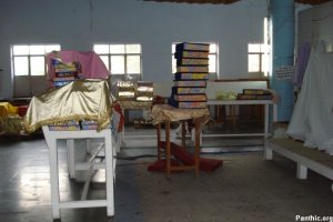 Holy Saroops of Sri Guru Granth Sahib Ji stacked like bricks, many of them uncovered.