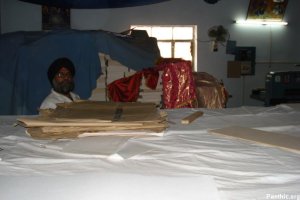 Rubbish and litter stored on top of Saroops of Guru Granth Sahib Ji stacked like bricks.