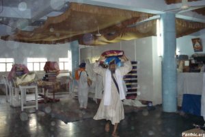 Guru Granth Sahib Satkar Committee Members moving some of the Saroops into the Sukhasan Room