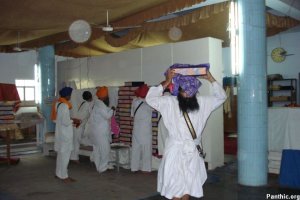 Guru Granth Sahib Satkar Committee Members moving some of the Saroops into the Sukhasan Room