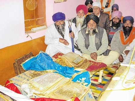 Sangat from Dawali area of Haryana inspecting the desecrated Saroops